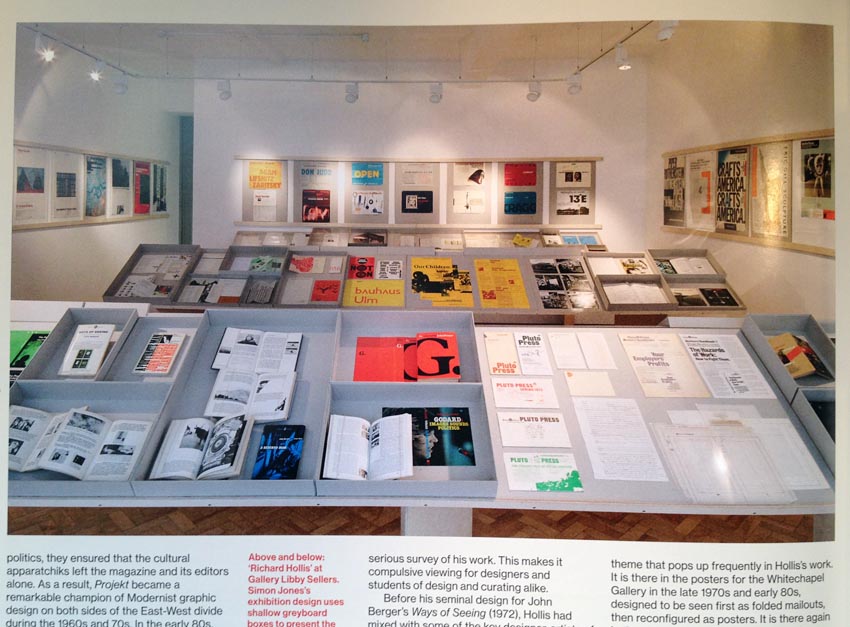 Photo showing books and other objects under glass on angled display tables