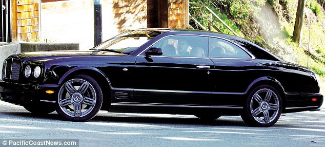 Vaguely unidentifiable man stares out of Bentley Brooklands driver’s-side window at us