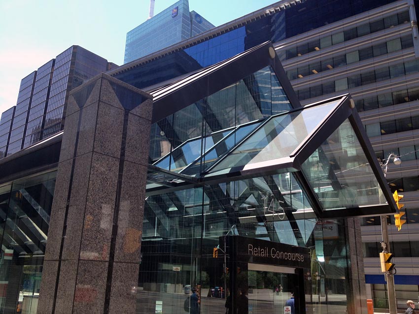 Multiple nested peaked roofs; tall granite column with triangular incision and seam running down each side