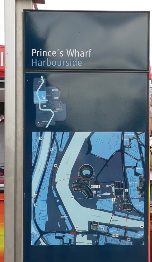 Tall rectangular sign reading Prince’s Wharf Harbourside at top, with a small map and a large overhead diagram