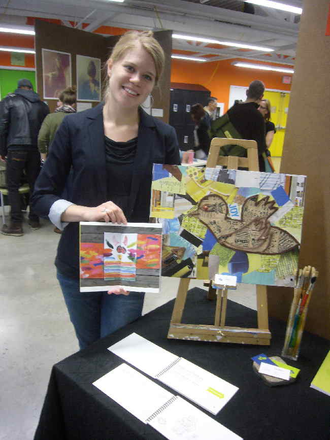 A smiling blonde Rebecca showing her project artwork