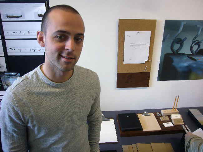 Thomas Albrighton, with desk set on table behind him