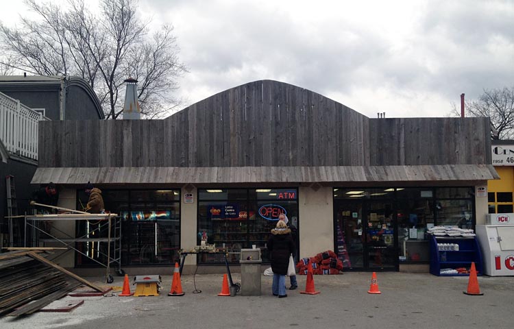 A-frame sign over convenience store is nothing but vertical grey boards