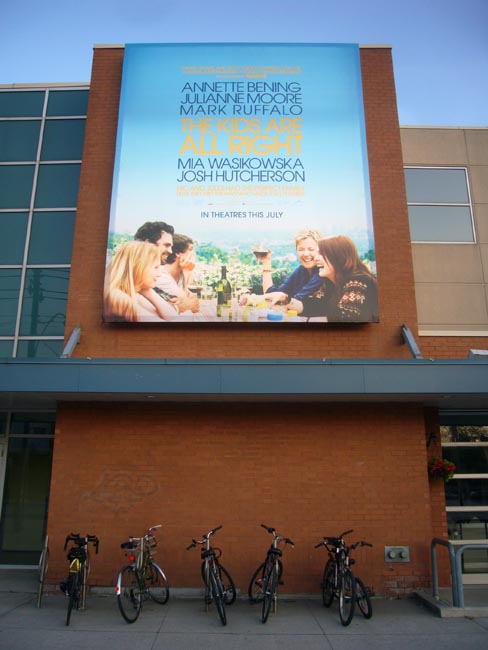 Banner atop cinema wall reads THE KIDS ARE ALL RIGHT