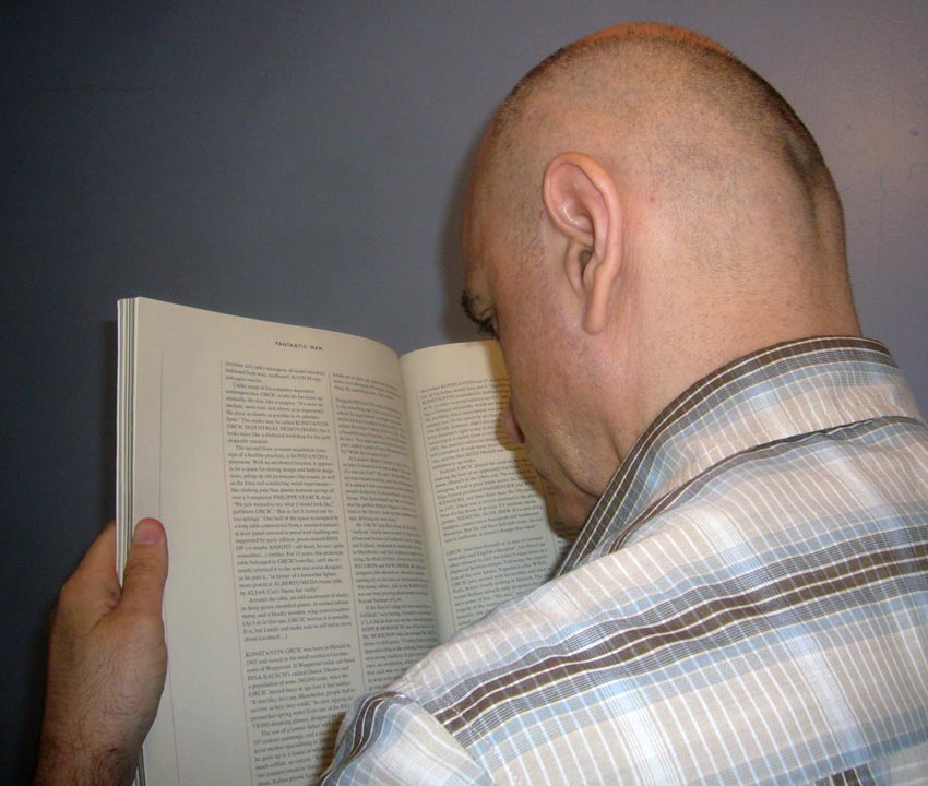 Me holding double-page text spread a foot from my nose