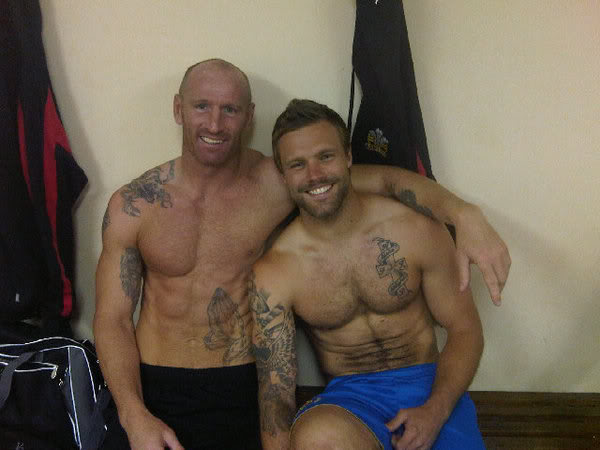 Shirtless, tattooed Gareth Thomas has arm around shoulder of shirtless, tattooed Nick Youngquest