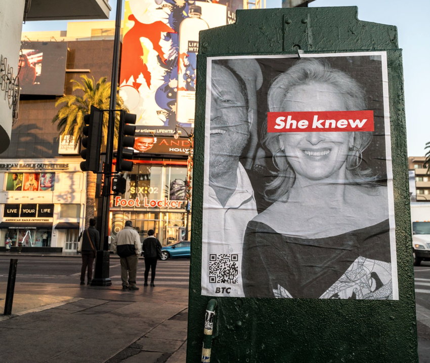 Poster shows B&W photo of Weinstein and Streep, with Streep’s eyes covered by “She knew” in white Futura on a red rectangle